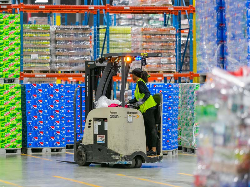 Woman operating forklift