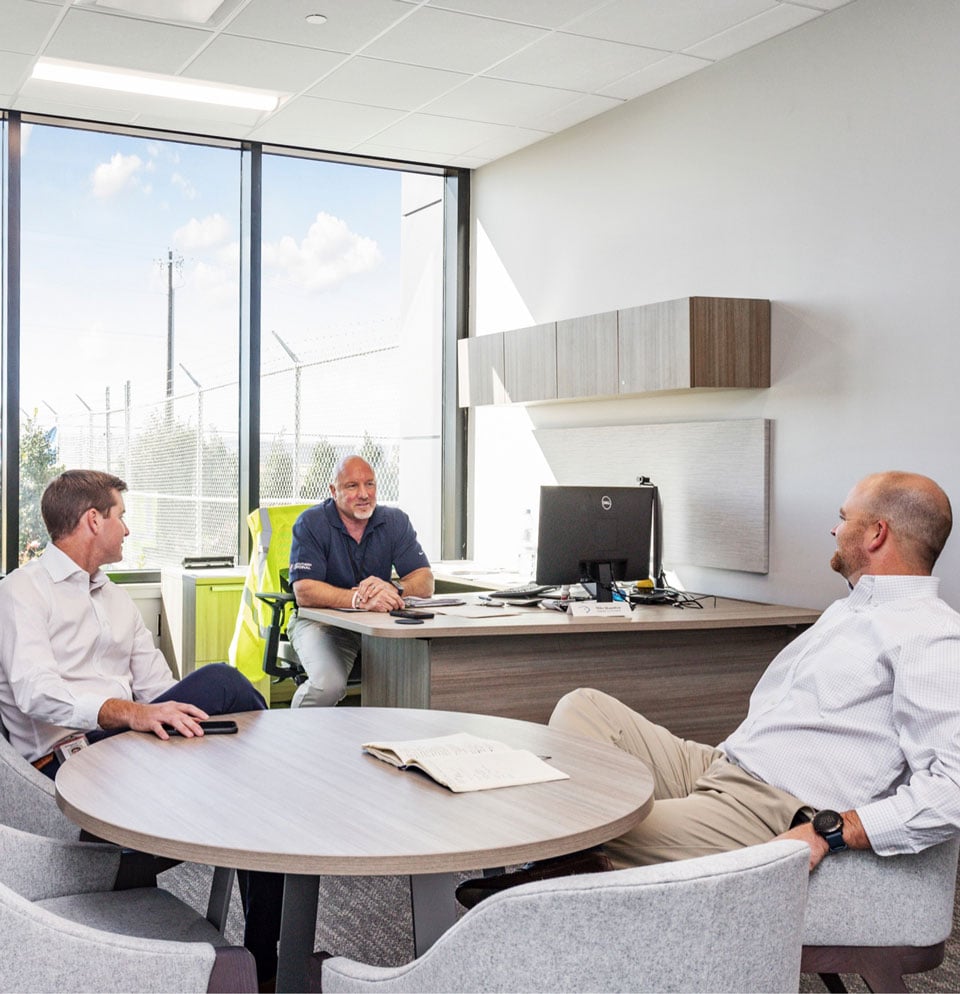 3 men talking in office