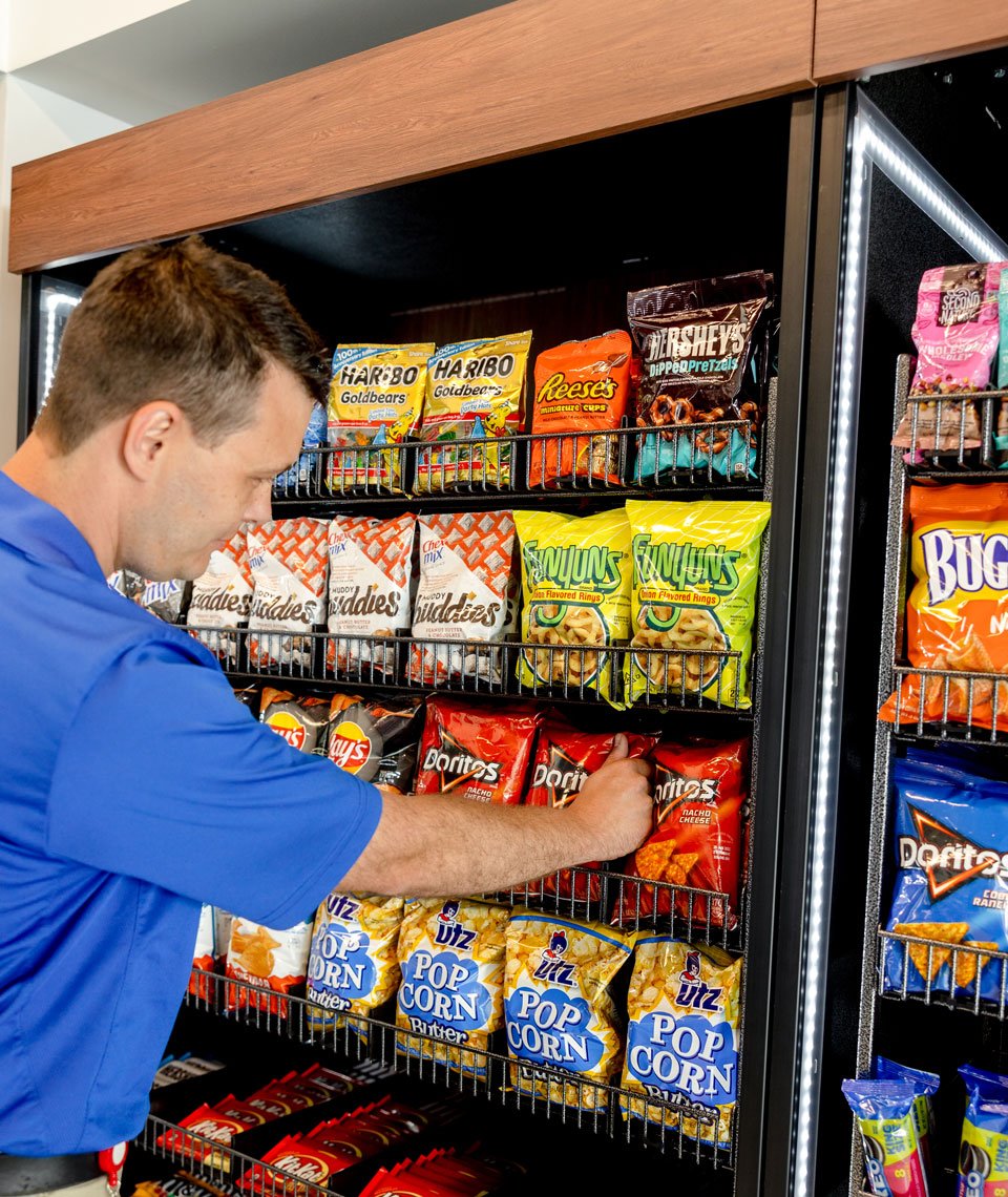 Employee refilling vending machine