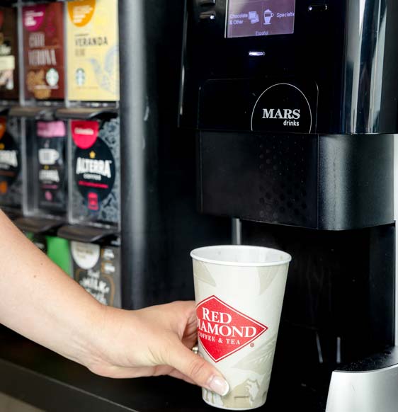 Woman filling up coffee cup